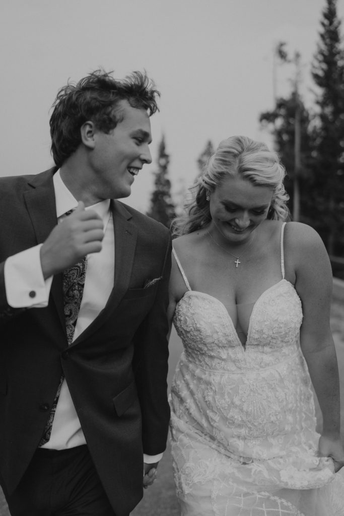 Black and white image of a couple smiling during their Woodlands at Cottonwood Canyon wedding in Bozeman, Montana. Image by Montana wedding photographer, Ashley J Photo.